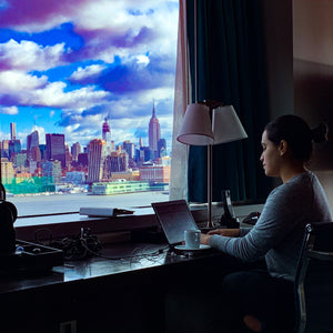 Klado founder, Jen Prado, working on a business plan overlooking New York City